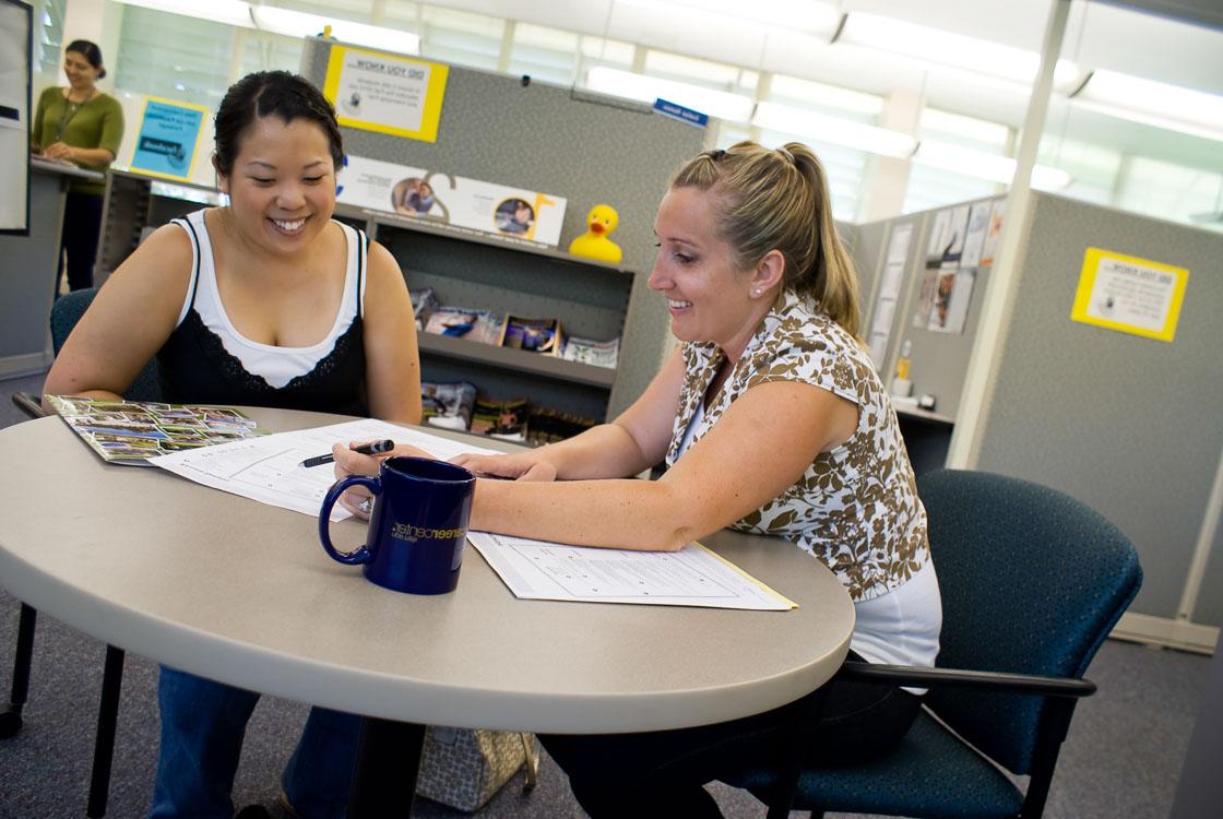 two people sitting at a desk